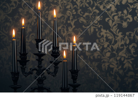 Black candles in stylish holders on a plain dark background. Minimalistic display for home Halloween decor concepts Black candles in stylish holders on a plain dark background. Minimalistic display for home Halloween decor concepts 119144867