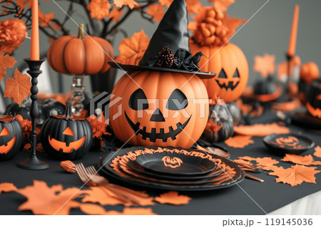Halloween themed table setting with black pumpkins, witch hats and ornate cutlery. Concept of spooky dining decor 119145036
