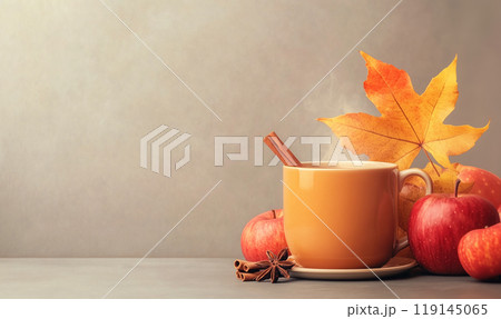 Warm beverage in mug with cinnamon sticks and colorful autumn leaves on a wooden surface. Autumn and cozy concepts 119145065