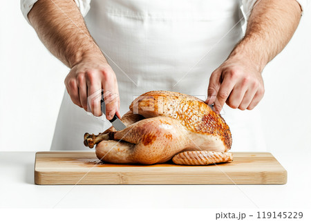 Carving roasted turkey or chicken isolated on wooden board. Concept of food for Thanksgiving Day. Carving roasted turkey or chicken isolated on wooden board. Concept of food for Thanksgiving Day. 119145229