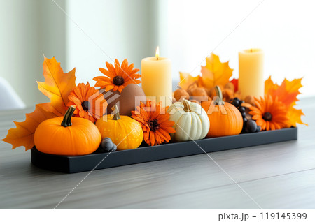 Autumn flat lay featuring pumpkins, candles, and leaves background. Concept of fall, harvest, and Halloween decoration Autumn flat lay featuring pumpkins, candles, and leaves background. Concept of fall, harvest, and Halloween decoration 119145399