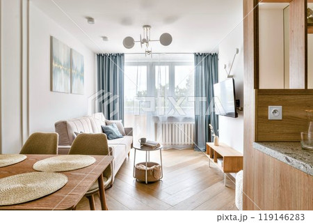 A Modern and Cozy Living Room That Features Abundant Natural Light and Stylish Decor Elements A Modern and Cozy Living Room That Features Abundant Natural Light and Stylish Decor Elements 119146283