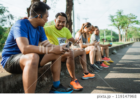 group athlete taking break after running group athlete taking break after running 119147968