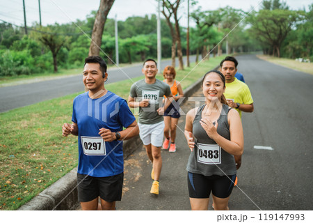 group of athletic people running on outdoor track 119147993
