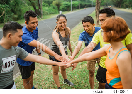 asian runners putting their hands together asian runners putting their hands together 119148004