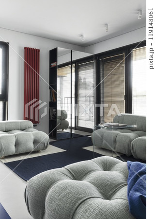 A modern living room with stylish seating and a sleek design, combining comfort and elegance A modern living room with stylish seating and a sleek design, combining comfort and elegance 119148061