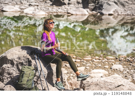Female Hiking in Mountains Drinking Water and Resting 119148848