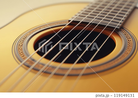A close up of a guitar with a yellow body and black strings 119149131