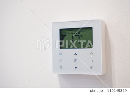 Smart thermostat on the white wall of the room. Smart thermostat on the white wall of the room. 119149239