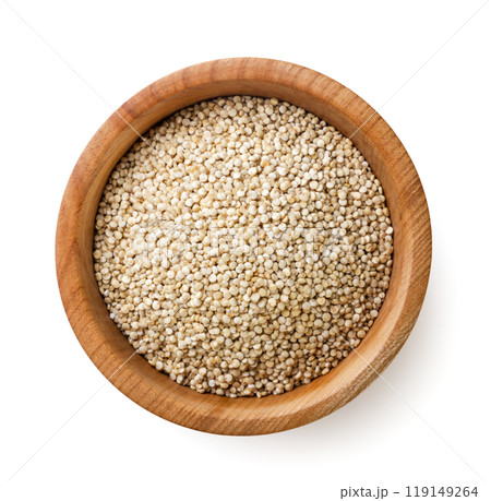 Quinoa grains in a wooden plate on a white background. Top view. 119149264