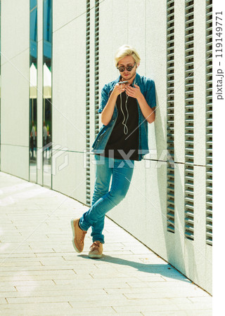 Hipster man listening music through earphones 119149771