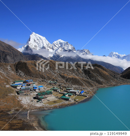 Lodges in Gokyo, turquoise lake and snow covered mountain Cholatse on a autumn day, Nepal. Lodges in Gokyo, turquoise lake and snow covered mountain Cholatse on a autumn day, Nepal. 119149949