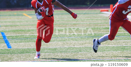 Football player running down the field after catching a pass 119150609