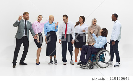 Lively group of diverse people, colleagues engage in animated conversation, with visible enthusiasm, showing inclusion and acceptance in the workplace. 119150642