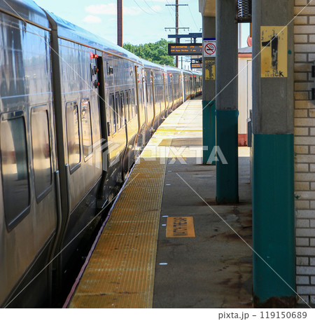Long Island Railroad Train arriving at the Babylon train station 119150689