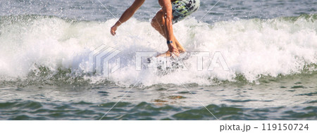 Man catching a wave riding on a kite board hydrofoiling in the ocean 119150724