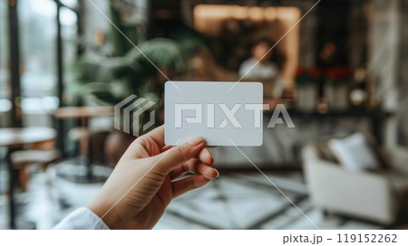 A hand presenting a blank credit card with the backdrop of a credit bureau office environment, Mock up or credit related concepts 119152262