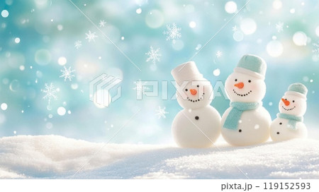 Charming snowmen on a snowy landscape with a soft blue background, perfect for winter-themed designs and holiday greetings. 119152593