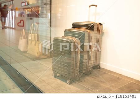Travelers choose baggage in the store.  119153403