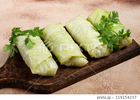 raw cabbage rolls, not cooked, with minced meat, top view, without people, in the spotlight. raw cabbage rolls, not cooked, with minced meat, top view, without people, in the spotlight. 119154237