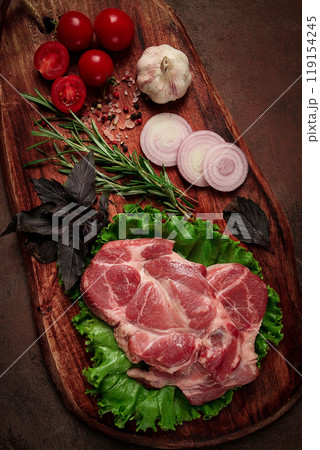 raw pork steak, two pieces, on a wooden background, raw pork steak, two pieces, on a wooden background, 119154245