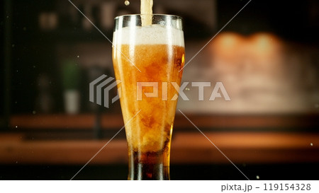 Close-up of beer pouring into pint , freeze motion. 119154328