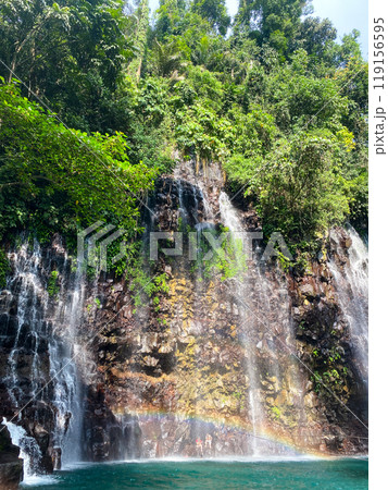 Tinago Falls with rainbow and green plunge pool. Lanao del Norte. Philippines. 119156595