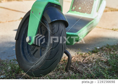 Front wheel of an electric scooter parked Front wheel of an electric scooter parked 119156698