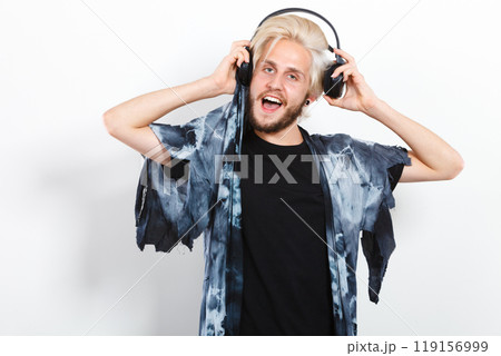 cool guy having fun listens to music in headphones 119156999