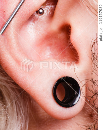 Pierced man ear, black plug tunnel, industrial and rook Pierced man ear, black plug tunnel, industrial and rook 119157080