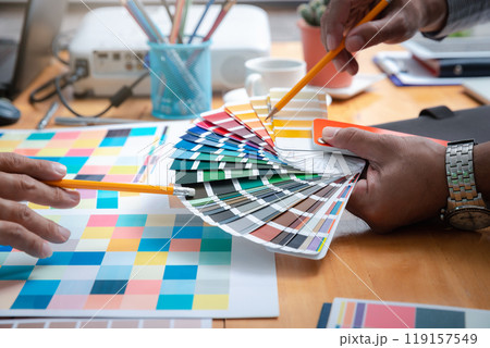 Interior designer chooses a color chart for home design. Graphic designers working on color chart at modern office. 119157549