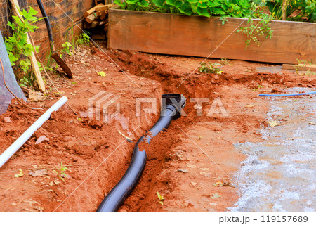 An open trench is dug for the purpose of laying drainage pipes for stormwater An open trench is dug for the purpose of laying drainage pipes for stormwater 119157689