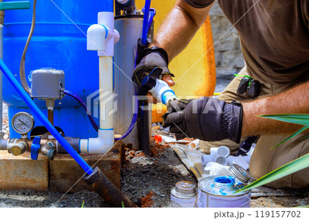 Plumbing work assembling connection between water well water system at house Plumbing work assembling connection between water well water system at house 119157702