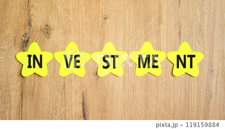 Investment symbol. Concept word Investment on beautiful yellow paper stars. Beautiful wooden background. Business investment concept. Copy space. Investment symbol. Concept word Investment on beautiful yellow paper stars. Beautiful wooden background. Business investment concept. Copy space. 119159884