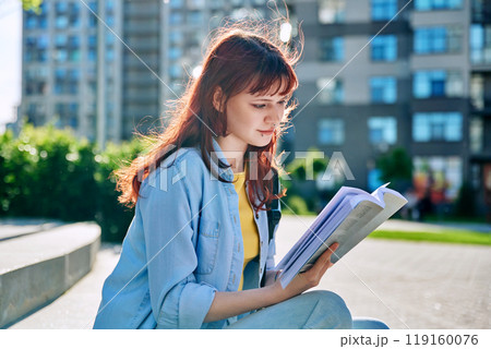 College student girl reading a book, outdoor College student girl reading a book, outdoor 119160076