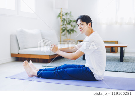 自宅のリビングでストレッチをする男性 119160281