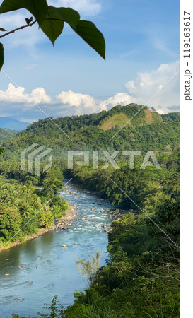 Mountain river and green forest. Blue sky with clouds. Mindanao, Philippines. Mountain river and green forest. Blue sky with clouds. Mindanao, Philippines. 119163617