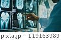 X-ray image of a human knee joint. Orthopedic surgeon doctor examining patient's knee joint x-ray films. Doctor examine patient's joint x-ray scan. 119163989