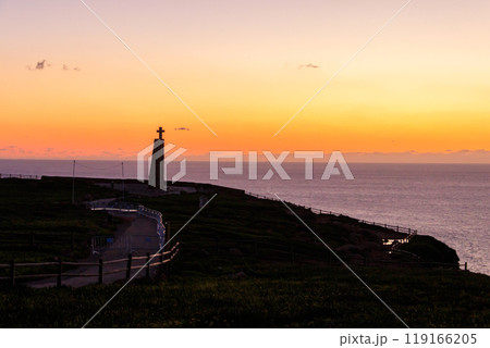 Cabo da Roca cross monument at sunset. Cabo da Roca or Cape Roca is westernmost cape of mainland Portugal, continental Europe and the Eurasian land mass Cabo da Roca cross monument at sunset. Cabo da Roca or Cape Roca is westernmost cape of mainland Portugal, continental Europe and the Eurasian land mass 119166205