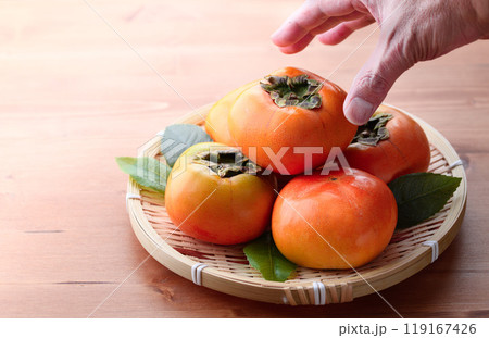 秋の味覚 笊に盛り付けた 柿 ( 木目背景 )柿の実 かき 果物 秋の味覚 笊に盛り付けた 柿 ( 木目背景 )柿の実 かき 果物 119167426