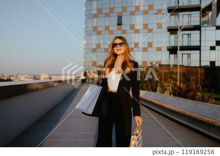 Woman with Shopping Bags Outdoor in City 119169256