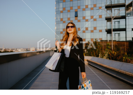 Woman Shopping Outdoors with Modern Building Background 119169257