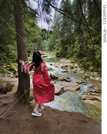 Woman in Red Dress by Serene Forest River Woman in Red Dress by Serene Forest River 119169341