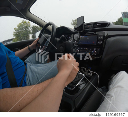 Couple Holding Hands in a Car on a Rainy Day Couple Holding Hands in a Car on a Rainy Day 119169367
