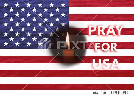 A solemn scene in Milton, Florida, where a single candle burns next to an American flag, symbolizing hope amidst tragedy. The community gathers in prayer after devastating events 119169910