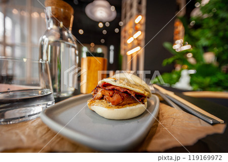Little Bao delicious chicken burger close up. Best asian burger ever. Not vegan. 119169972