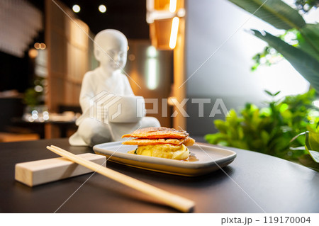 Sea bass fillet on a bed of mashed potatoes and spinach close-up on a gray plate 119170004
