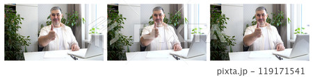 Smiling Man at Desk Giving Thumbs Up Smiling Man at Desk Giving Thumbs Up 119171541