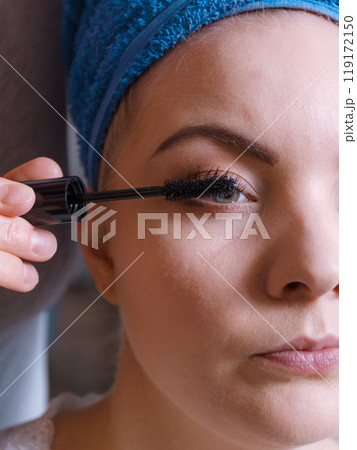 Woman getting her make up done by expert 119172150