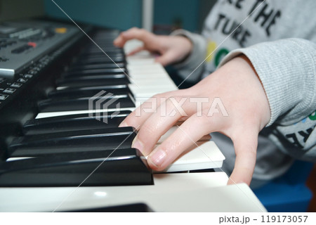 Close up of happy woman's hand playing the piano in the morning. Close up of happy woman's hand playing the piano in the morning. 119173057